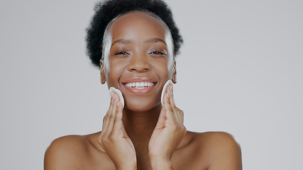 Image showing Face, model and hands with cotton for beauty, facial and cosmetic with happiness in studio background. Black woman, healthy skin and dermatology with self care, spa treatment and aesthetic portrait