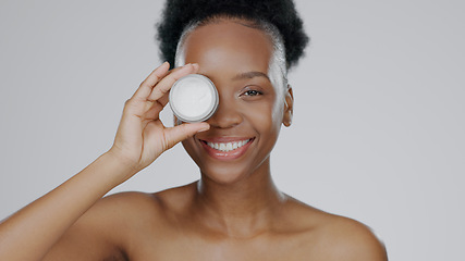 Image showing Face, model and hands with eye cream for cosmetic, hand gesture and beautiful skin in studio background. Black woman, moisturizer and serum for dermatology with self care portrait and smile in mockup
