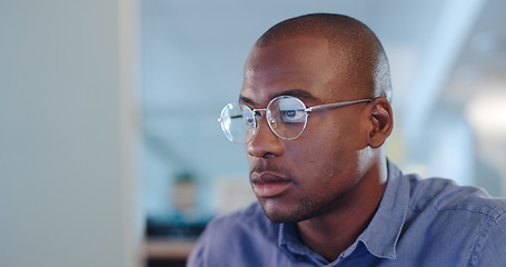 Image showing Serious black man, computer and focus for research, project deadline or trading at office. African male person, designer or employee working on PC or reading email, information or tasks at workplace