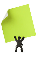 Image showing Figurine holding a piece of blank yellow paper