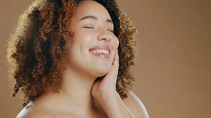 Image showing Face of happy woman, natural beauty mockup space or cosmetics for wellness in studio with smile. Skin glow, pride or confident biracial female model with skincare results isolated on brown background