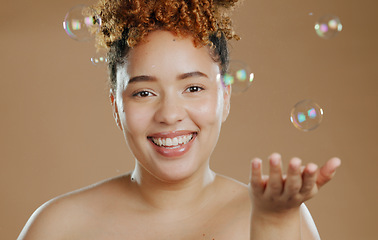 Image showing Portrait, skincare and woman with bubbles in studio for beauty in mockup with brown background. Person, model and smile with satisfaction for wellness with treatment, smooth and glow of face