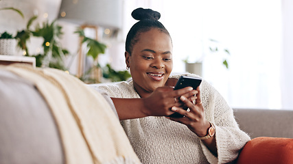 Image showing Black woman, reading and using phone with smile in home or social media, mobile app and communication online. Funny, meme or person on couch streaming video or typing on cellphone in living room