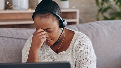 Image showing Stress, customer support and remote work with a black woman consultant on a sofa in the living room of her home. Depression, headache and an unhappy employee problem solving for help or assistance