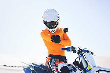 Image showing Moto, person or rider with injury on bike in desert for sports on holiday, vacation or trip in Namibia. Driver, elbow and pain with activity, fearless or fast for fun in summer with, people or race