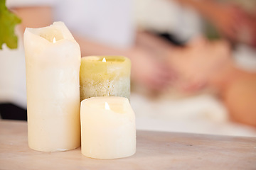 Image showing Zen, table and candles at spa during massage for relax, wellness and lighting at a hotel. Calm, peace and a flame in a room for a luxury treatment, aroma therapy or ambient experience for hospitality