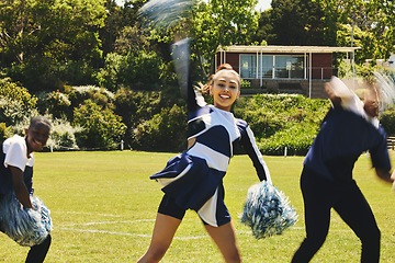 Image showing Cheerleader, people and teamwork with hand up in routine at university stadium, sport and uniform for game. Asian teen, diversity and team in collaboration with pom poms and fitness for competition