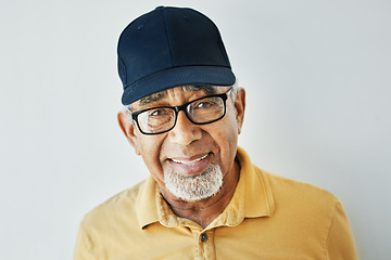 Image showing Elderly man, hat and glasses with modern style, casual and trendy fashion in studio with smile. Happy indian man, retired and model with contemporary clothes in closeup by grey isolated background