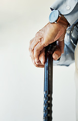 Image showing Elderly, person and hand with walking stick in closeup for assistance, walk or health in nursing home. Wrinkles, fingers and hold on blurred background for retirement, support or wellness in facility