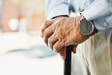 Image showing Senior, hands and stand with cane in closeup for retirement, vacation or trip on blurred background. Elderly, person and wrinkles with health, medical care or wellness in rehabilitation for injury