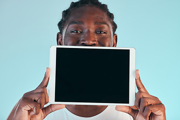 Image showing Tablet, screen and black man with mockup in studio with news, promo or announcement on blue background. Digital, offer and portrait of African male model show space for social media, sign up or deal