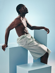 Image showing Body, black man and thinking profile in studio with art, skincare and glow from skin wellness and confidence. Strong muscle and African male model with creative blue background and relax with power