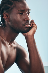 Image showing Thinking, beauty and black man with cometic skincare and smooth aesthetic isolated in a studio blue background. Care, dermatology and young shirtless person with natural calm, relax and skin