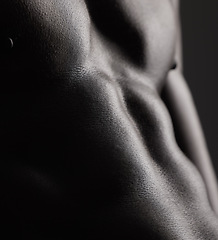 Image showing Fitness, man and torso with closeup in studio for wellness, stomach and body on dark background. Person, muscle and bodybuilder with six pack and muscular, healthy lifestyle with muscles and topless