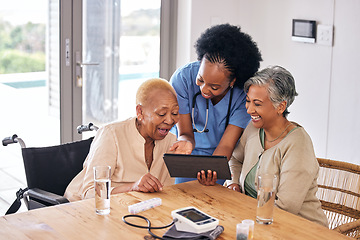 Image showing Tablet, smile and an assisted living caregiver with old women in the kitchen of a retirement home for consulting. Blood pressure, medical and an african nurse showing information to patient friends