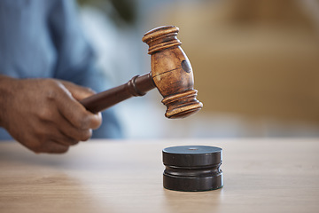 Image showing Gavel, hand of lawyer or judge in office for decision, attention or legal advice in justice system. Hammer, desk and person in courtroom, law firm or government agency to stop hearing in human rights