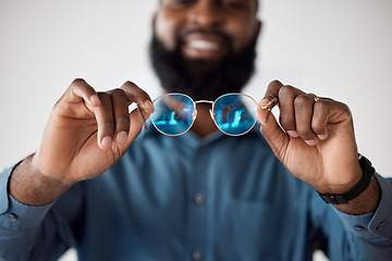 Image showing Optometry, closeup and a black man showing glasses for healthcare, consulting or an exam. Lens, happy and an African person holding prescription eyewear to check the frame for vision or eye care