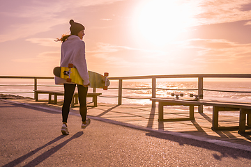 Image showing Girl holding a skateboard 