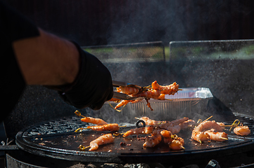 Image showing A professional cook prepares shrimps