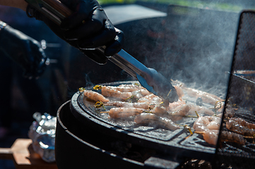 Image showing A professional cook prepares shrimps