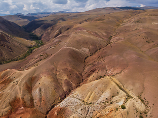 Image showing Aerial shot of the textured yellow nad red mountains resembling the surface of Mars