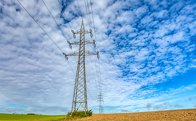 Image showing High voltage power lines against a blue sky