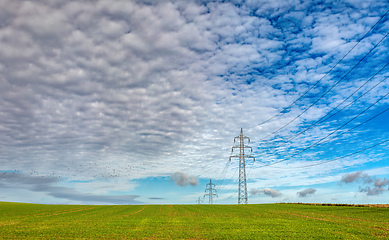 Image showing High voltage power lines against a blue sky