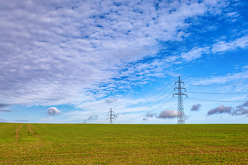 Image showing High voltage power lines against a blue sky