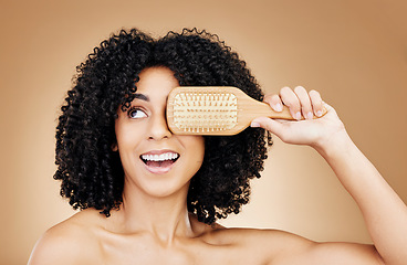 Image showing Hair, beauty and woman with afro brush for style isolated in a studio brown background for wellness and skincare. Comb, natural and young person with cosmetic aesthetic in Brazil hairdresser