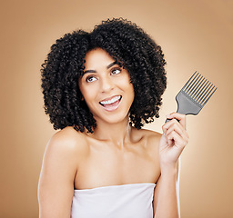 Image showing Hair, beauty and woman thinking with comb for style isolated in a studio brown background for wellness and skincare. Texture, natural and young person with cosmetic aesthetic in Brazil hairdresser