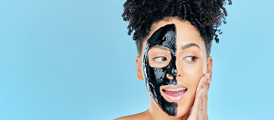 Image showing Mockup, charcoal mask and face of woman for facial treatment, anti aging detox and wellness in studio. Beauty, salon and person for healthy skin, cosmetics and grooming on blue background space