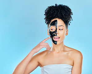 Image showing Skincare, charcoal mask and face of woman for facial treatment, anti aging and wellness in studio. Beauty mockup, dermatology and person for healthy skin, cosmetics and grooming on blue background