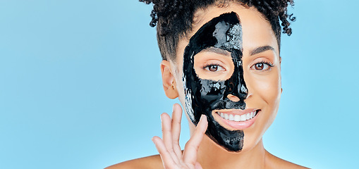 Image showing Skincare, charcoal mask and portrait of happy woman for facial treatment, spa and wellness in studio. Beauty, dermatology and face of person for health, cosmetics and grooming on blue background