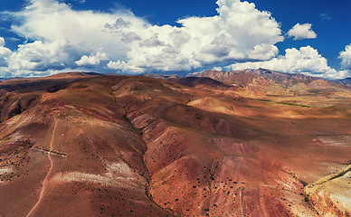 Image showing Aerial shot of the textured yellow nad red mountains resembling the surface of Mars