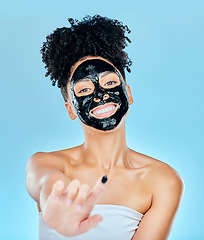 Image showing Skincare, face mask and portrait of woman with finger for facial treatment, anti aging or wellness. Beauty, studio and happy person apply products for health, cosmetics or grooming on blue background