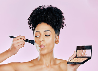 Image showing Makeup brush, palette and studio face of woman with tools, beauty routine and apply cosmetics powder, foundation or product. Mirror, facial transformation process and salon person on pink background