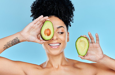 Image showing Skincare, avocado and happy woman in studio for cosmetic, wellness and treatment on blue background. Beauty, fruit and female model smile with organic, dermatology or detox for glowing skin routine