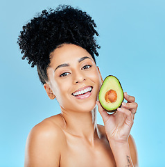 Image showing Happy woman, portrait and avocado for natural skincare, beauty or diet against a blue studio background. Face of female person smile with organic vegetable for nutrition, vitamin C or skin wellness