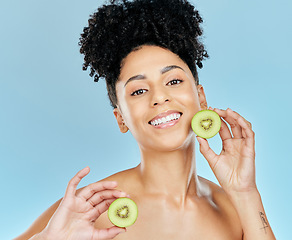 Image showing Skincare, beauty and portrait of woman with kiwi in studio for glowing skin or wellness on blue background. Face, shine and female model with fruit for natural cosmetics, dermatology or treatment