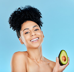 Image showing Happy woman, portrait and avocado for natural beauty, skincare or diet against a blue studio background. Face of female person smile with organic vegetable for nutrition, vitamin C or skin wellness