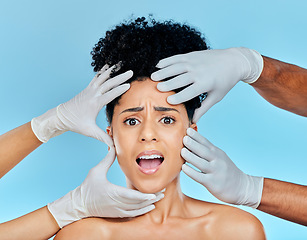 Image showing Skincare, portrait of scared woman with hands on face in studio for plastic surgery consultation. Model with stress, fear and anxiety for beauty, dermatology or collagen therapy on blue background.