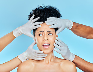 Image showing Plastic surgery, facial and scared woman with hands on face in studio for skincare consultation. Model with stress, fear and anxiety for beauty, dermatology or collagen therapy on blue background.