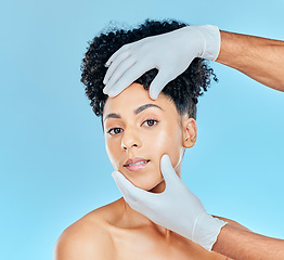 Image showing Beauty, plastic surgery and portrait of woman with hands on face in studio for cosmetic facial consultation. Skincare, dermatology and professional collagen therapy, face of model on blue background.