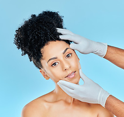 Image showing Facial, plastic surgery and portrait of woman with hands on face in studio for cosmetic beauty consultation. Skincare, dermatology and professional collagen therapy, face of model on blue background.