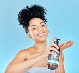 Image showing Skincare, portrait and happy woman with body cream bottle, container or product for self care, collagen or skin hydration. Morning routine, dermatology studio and salon girl smile on blue background