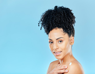 Image showing Skincare, body cream and portrait of woman in studio for lotion application on blue background. Face, beauty and female wellness model with sunscreen, moisturiser or dermatology, cosmetics or glow