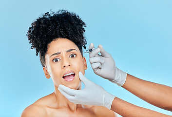 Image showing Filler, portrait of scared woman with hands on face in studio for collagen skincare consultation. Model with stress, fear and anxiety for beauty, dermatology or cosmetic process on blue background.