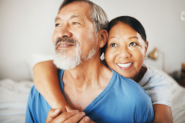 Image showing Love, smile and senior couple hugging in the bedroom for bonding, thinking and relaxing together. Happy, care and elderly Asian man and woman in retirement embracing for connection by modern home.