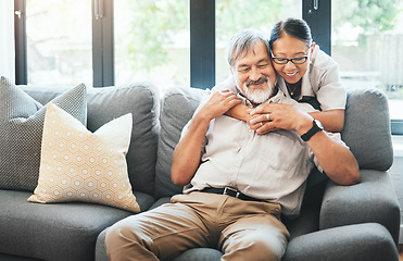 Image showing Home, hug and old couple on a couch, marriage and love with retirement, smile and commitment. Apartment, senior man or mature woman on sofa, speaking and support with relationship, embrace or bonding