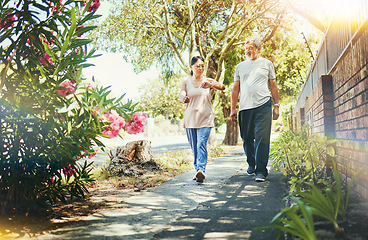 Image showing Street, neighborhood and senior couple walking as fitness , exercise and outdoor workout together as wellness. Health, time and calm elderly people on retirement training muscle or sport freedom